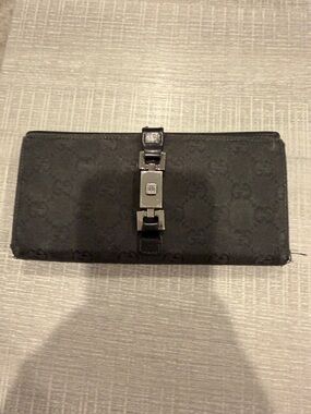 Authentic Gucci monigrammed black wallet. Silver hardware. Well loved condiron.
